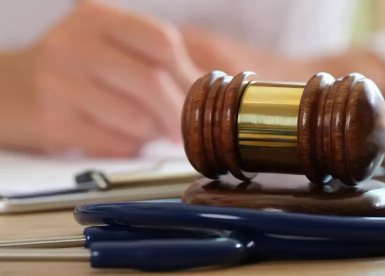 a wooden judge's gavel sitting on top of a desk