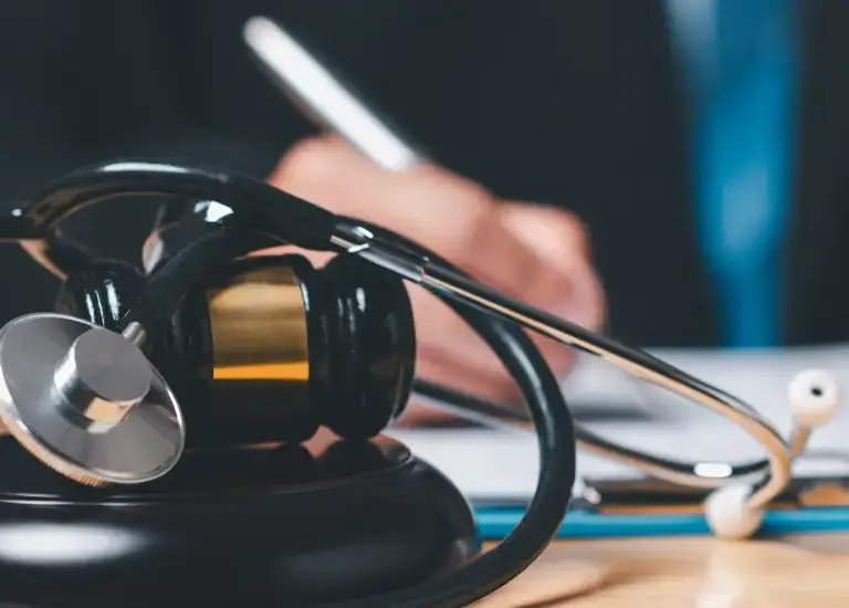 a person sitting at a desk with a laptop and headphones
