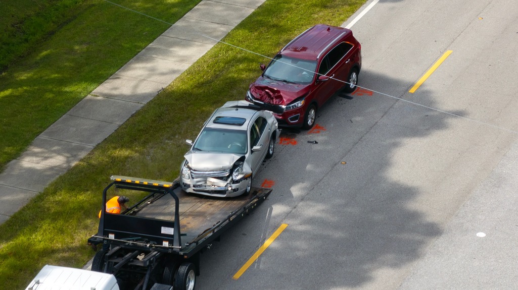 Tow truck loading crashed car on accident site