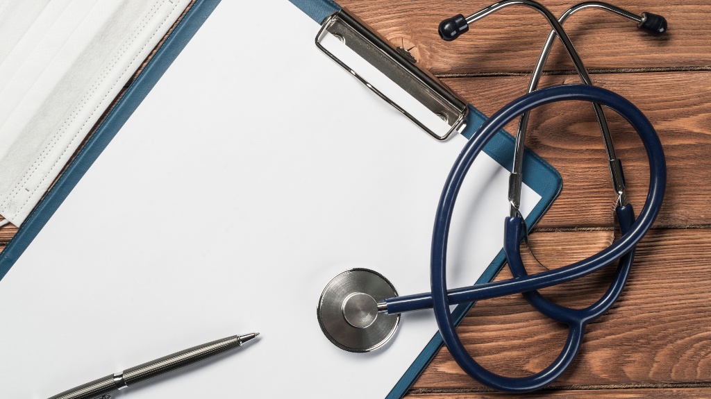 Doctors wooden table with tablet stethoscope