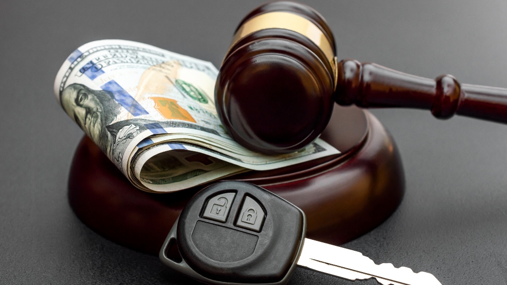 Judge's gavel with car key and money