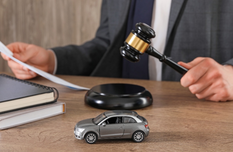 Man with document and gavel at wooden table