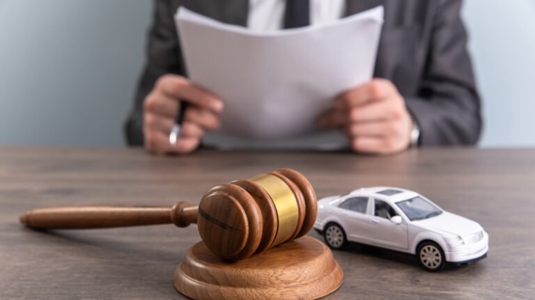 Model of car and gavel