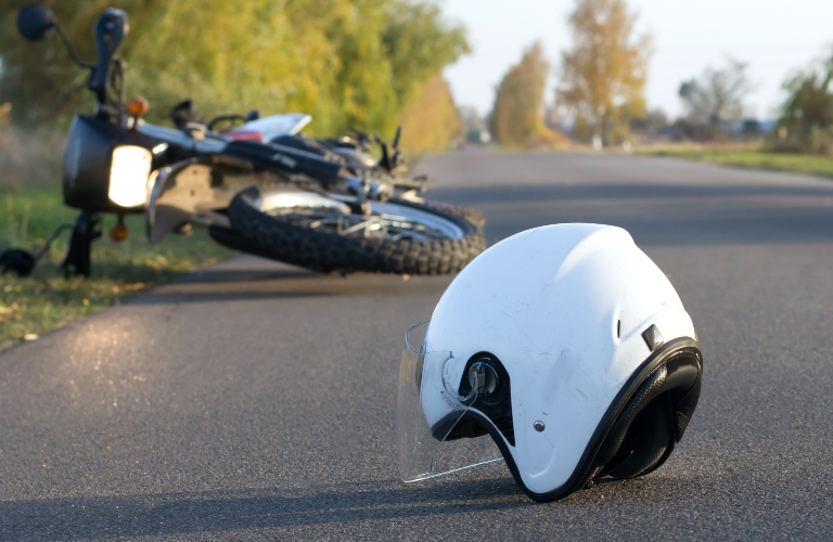 helmet and motorcycle on the road after an accident