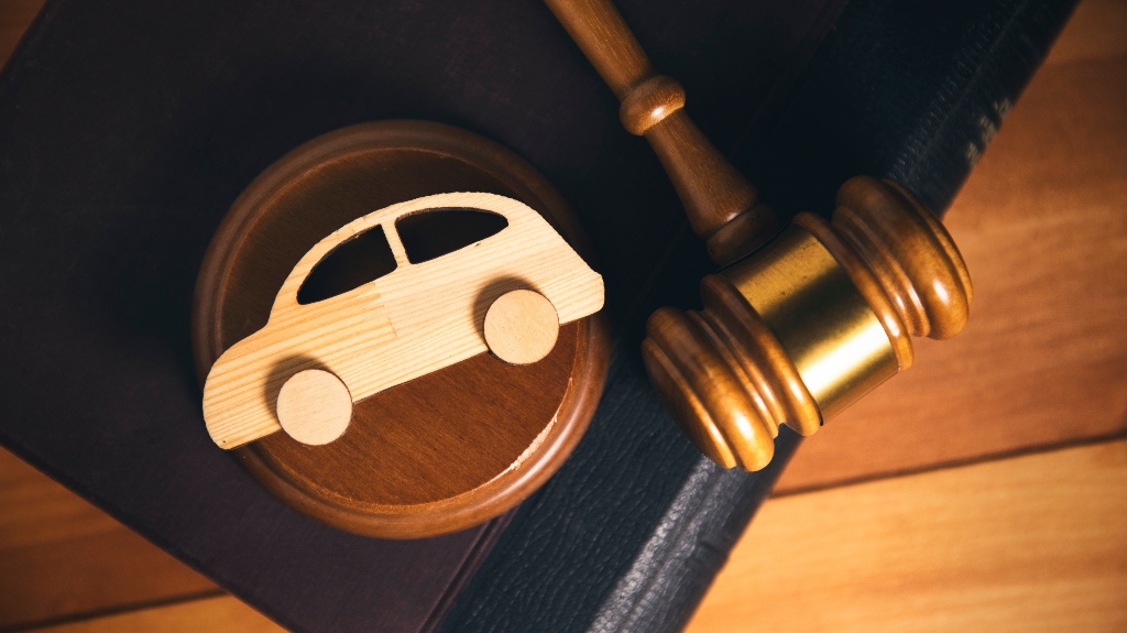 Wooden model of a car and judge gavel