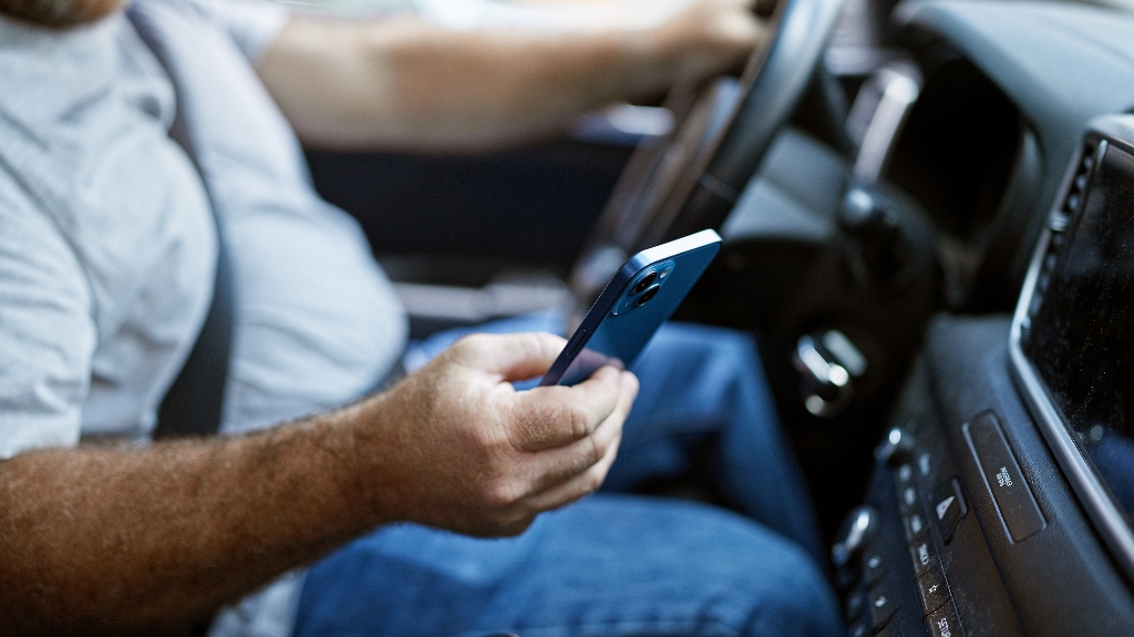 man is using phone during driving