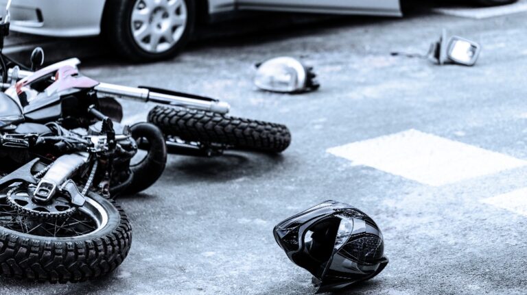Helmet and motorcycle on the street after accident