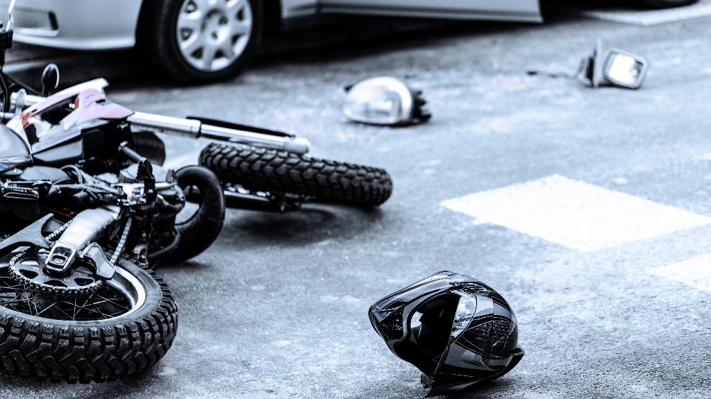 Helmet and motorcycle on the street after accident