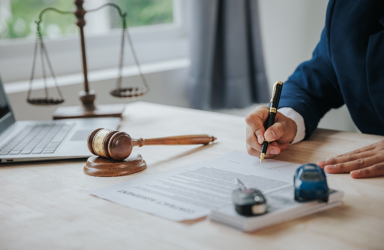 lawyer's hand with car and documents