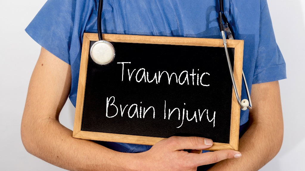 Doctor shows information on blackboard_ traumatic brain injury