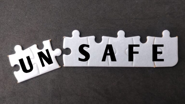 White puzzle with text UN SAFE on black background